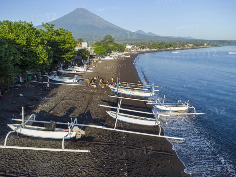 Fishermen loading fish from their outrigger boats in the morning on the black beach of Amed, Amed, Karangasem, Bali, Indonesia, Asia