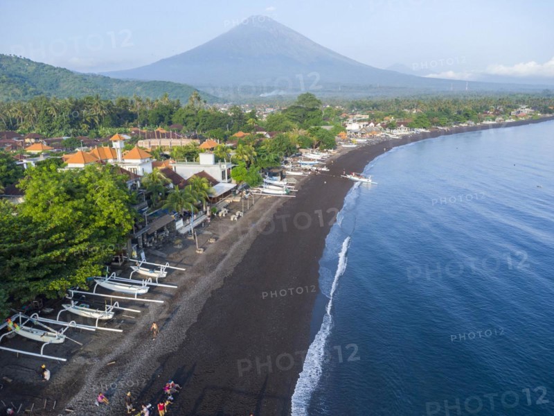 Fishermen loading fish from their outrigger boats in the morning on the black beach of Amed, Amed, Karangasem, Bali, Indonesia, Asia