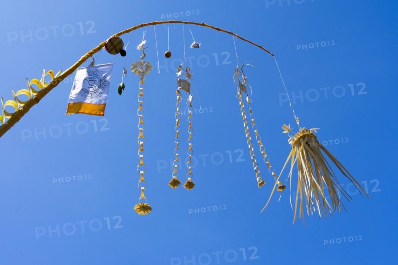 Artfully woven palm leaf jewellery on bamboo poles, on a village street in Amed, Karangasem, Northeast Bali, Indonesia, Asia