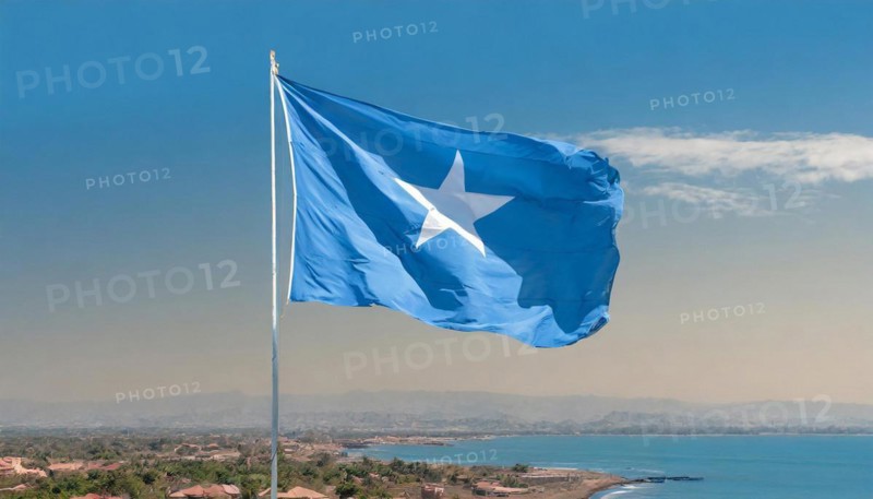 The flag of Somalia, fluttering in the wind, isolated, against the blue sky