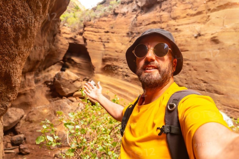 Selfie of a man enjoying in the limestone canyon Barranco de las Vacas in Gran Canaria, Canary Islands