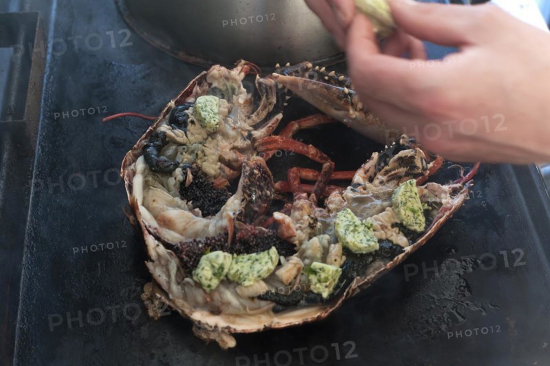 Cooked lobster (homarus) with caviar, vegetables and garlic butter on a plancha, Atlantic coast, Vandee, France, Europe