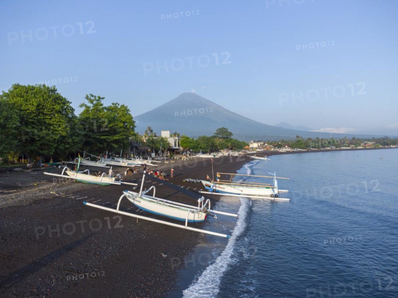 Fishermen loading fish from their outrigger boats in the morning on the black beach of Amed, Amed, Karangasem, Bali, Indonesia, Asia