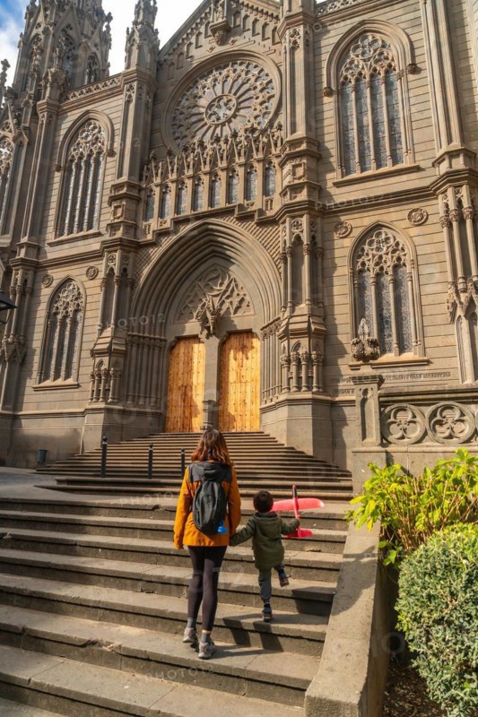 A mother with her son visiting the Church of San Juan Bautista, Arucas Cathedral, Gran Canaria, Spain, Europe