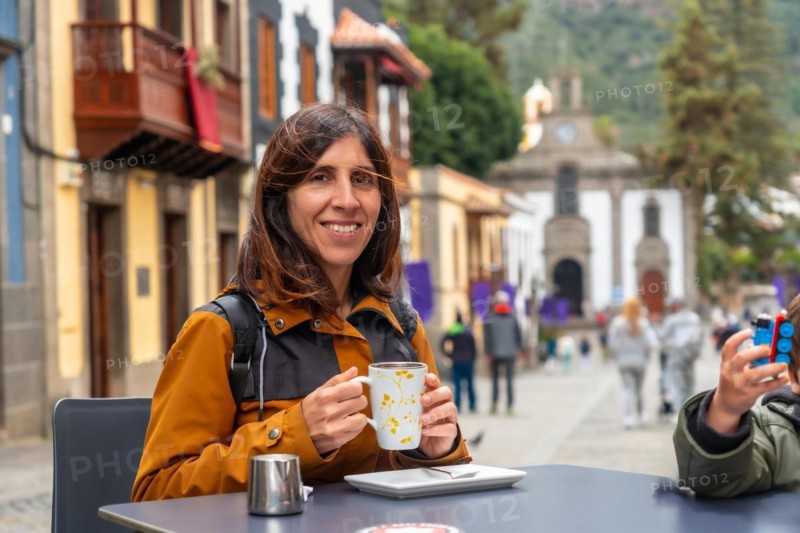 A tourist woman resting and having a coffee in the municipality of Teror. Gran Canaria, Spain, Europe