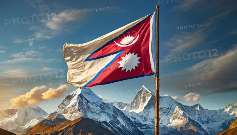 The flag of Nepal, fluttering in the wind, isolated against a blue sky