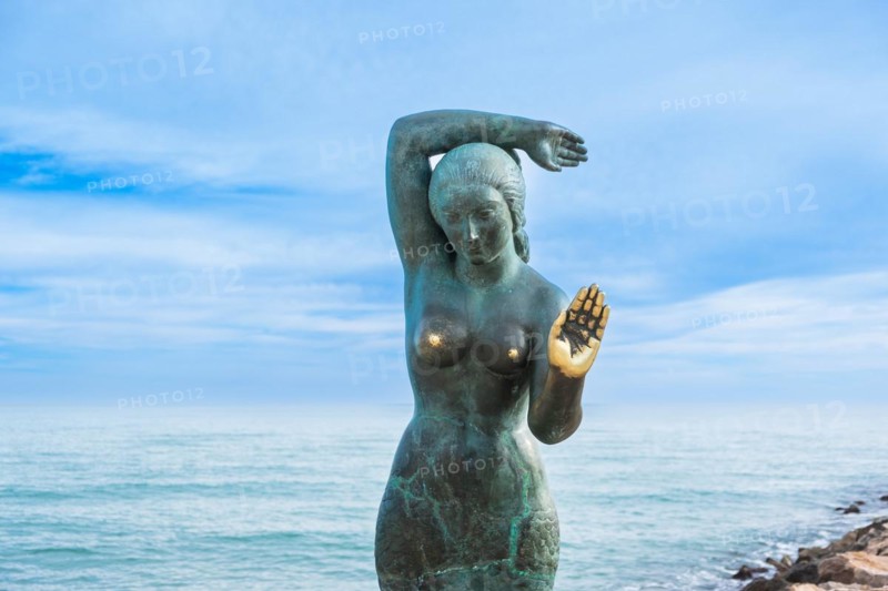 Bust of a siren or mermaid with worn hands and breasts in Sitges, Spain, Europe