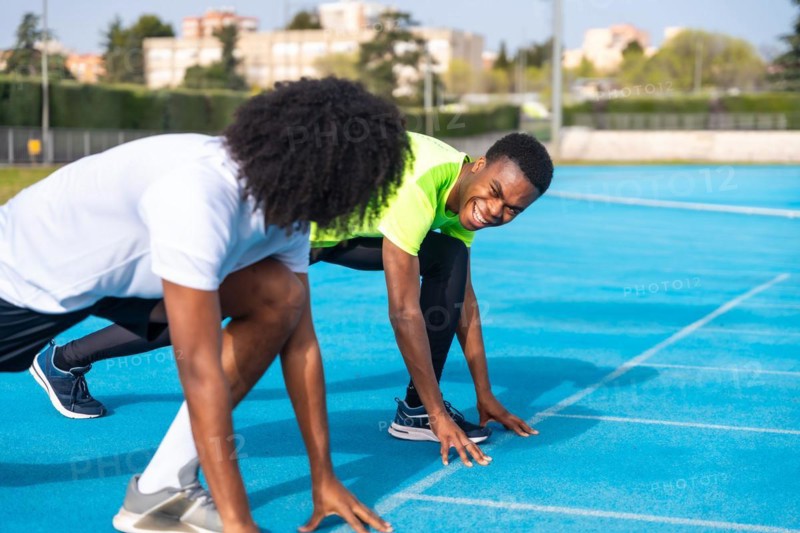 African athletes in starting position to begin running on an athletics track