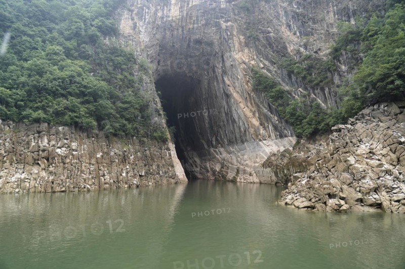 Cruise ship on the Yangtze River, Hubei Province, China, Asia, A cave opens into a rock next to a river with green water, Yichang, Asia