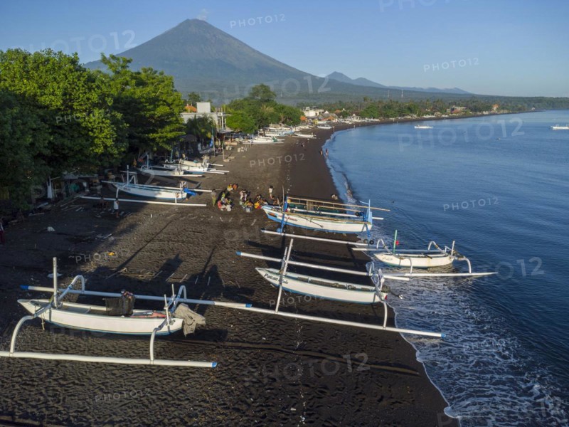 Fishermen loading fish from their outrigger boats in the morning on the black beach of Amed, Amed, Karangasem, Bali, Indonesia, Asia