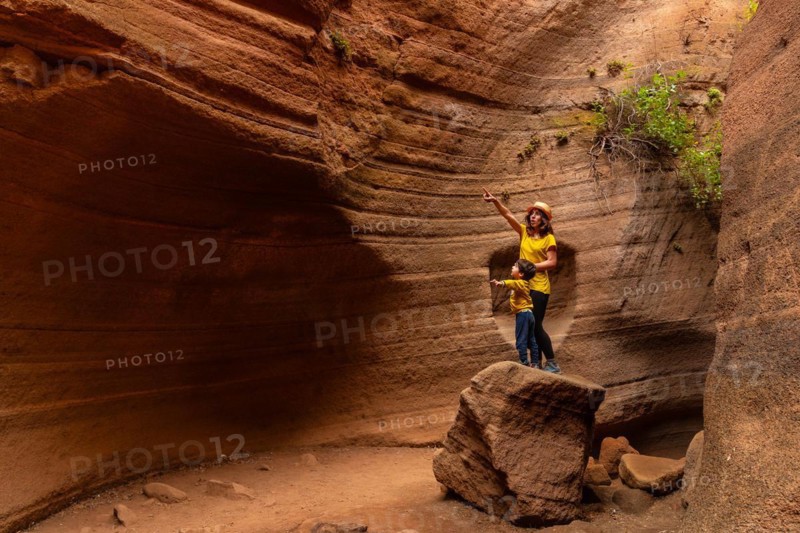 Mother and son enjoying in the limestone canyon Barranco de las Vacas in Gran Canaria, Canary Islands