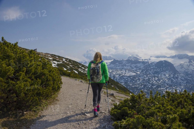 Tourist woman trekking on Mount Krippenstein in the Dachstein Mountains of Upper Austria, Salzkammergut region, Austria, Europe