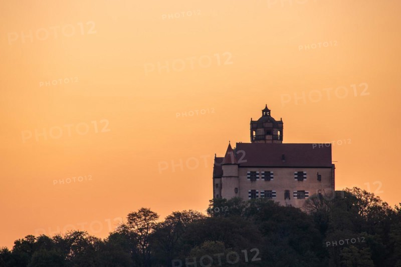Landscape at sunrise. Beautiful morning landscape with fresh yellow rape fields in spring. Small castle in the yellow fields on a hill. Historic Ronneburg Castle in the middle of nature, Ronneburg, Hesse, Germany, Europe