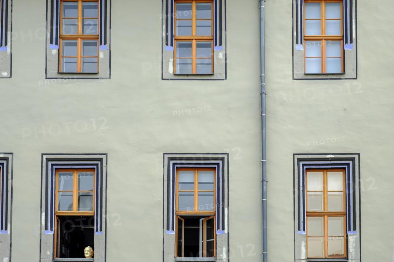 The bust of Johann Wolfgang von Goethe in the lower left window in rows of windows of the Red Palace, a Renaissance building in Weimar, Thuringia, Germany, Europe