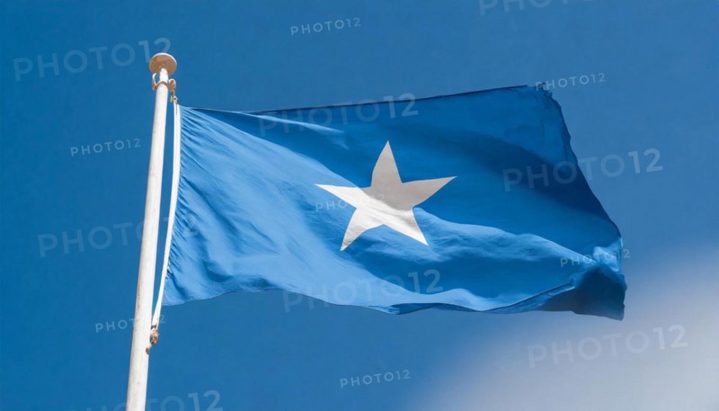 The flag of Somalia, fluttering in the wind, isolated, against the blue sky