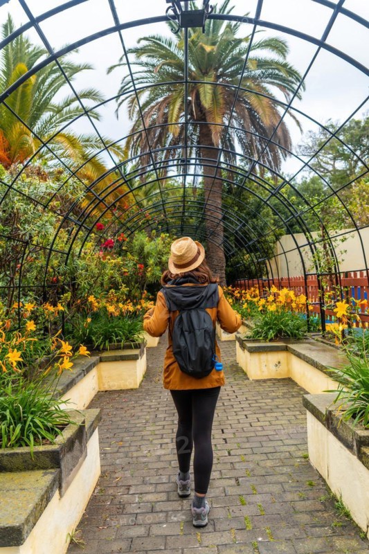A woman walking through a beautiful botanical garden, a sustainable tourism concept in Arucas, Gran Canaria. Spain