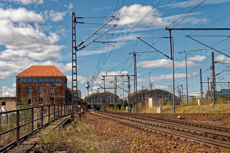 In the foreground, the railway tracks and Postbahnhof Berlin building and the Ostbahnhof station concourse 2015, Berlin