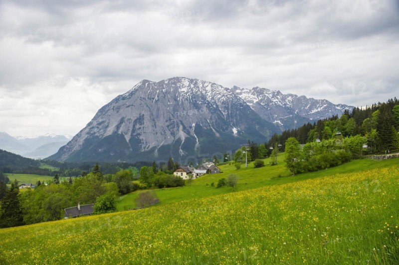 Summer austrian landscape with Grimming mountain (2.351 m), an isolated peak in the Dachstein Mountains, view from small alpine village Tauplitz, Styria, Austria, Europe