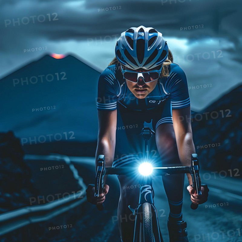 Cyclist on a road at night with headlights and mountains in the background, AI generated