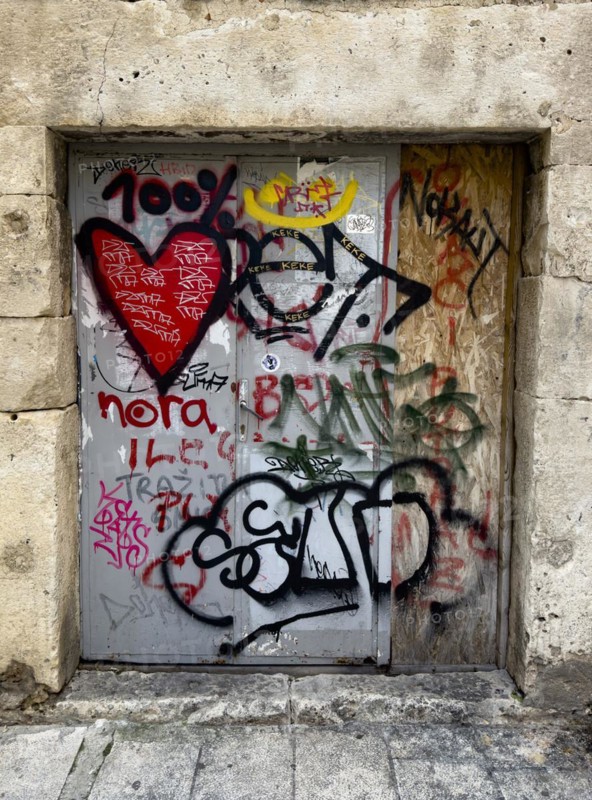 Heavy door full of graffiti and tags in an old city wall, Split, Dalmatia, Croatia, Europe