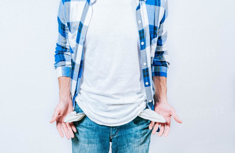 Person showing his empty pockets. Concept of financial problems