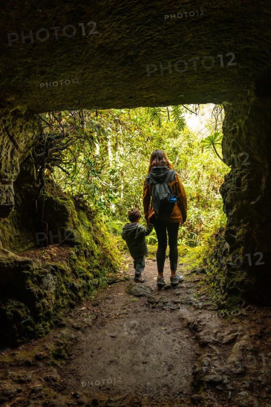 A child and his mother in a cave in the Laurisilva forest of Los tilos de Moya, Gran Canaria