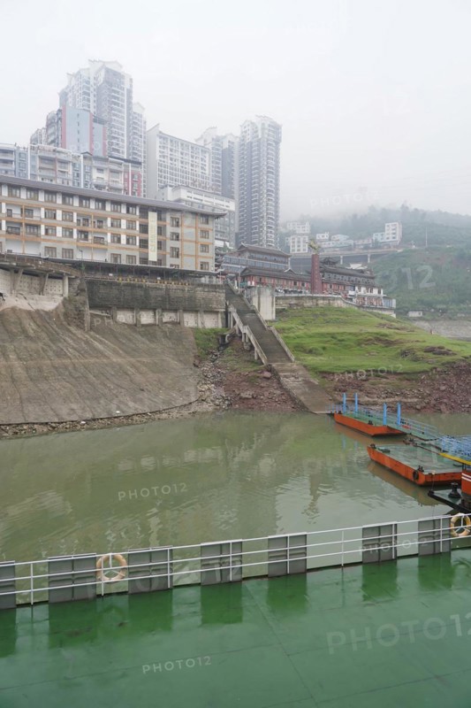 Yichang, Hubei Province, China, Asia, A cloudy day with a view of a river, multi-storey buildings under a grey sky, Asia