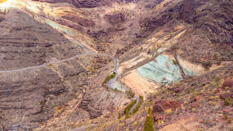 Aerial view of the Azulejos de Veneguera or Rainbow Rocks Natural Monument in Mogan, Gran Canaria