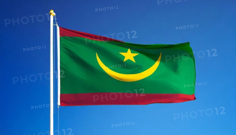 The flag of Mauritania, Mauritania, flutters in the wind, isolated against a blue sky, Africa