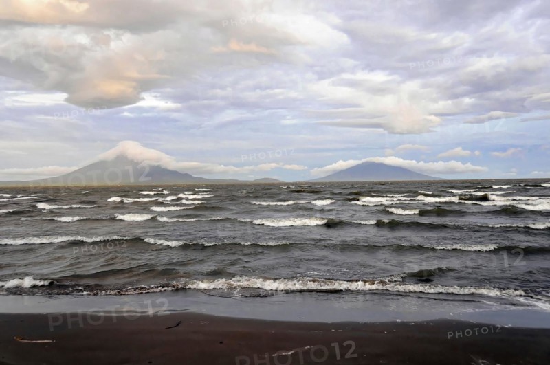 Underway near Rivas, Lake Nicaragua, Ometepe Island in the background, Nicaragua, Wave breaking on the shore of a lake with volcanoes on the horizon, Central America, Central America