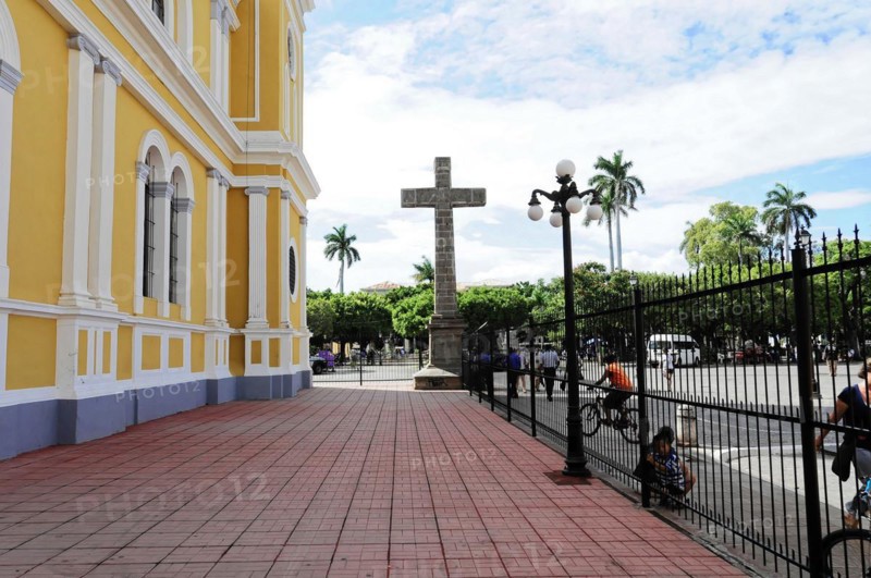 Granada, Nicaragua, forecourt of a yellow church with a large cross, surrounded by a wrought-iron railing and palm trees, Central America, Central America -, Central America