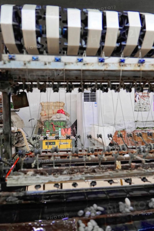 Silk factory Shanghai, close-up of a weaving machine with stripe pattern in a textile factory, Shanghai, China, Asia