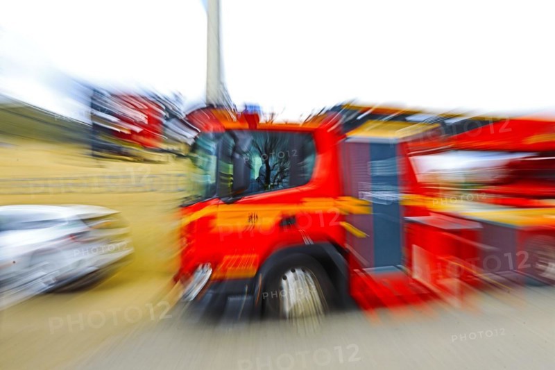 Fire engine in motion with strong blur, suggesting dynamics