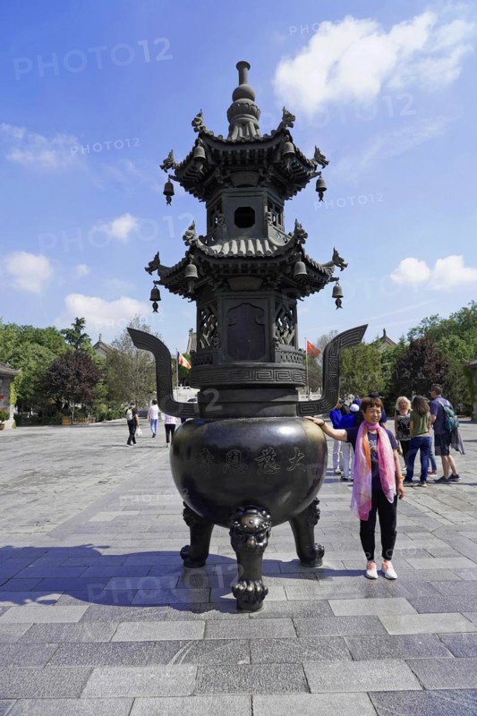 Chongqing, Chongqing Province, China, Asia, Large traditional Chinese incense burner on a square with a person next to it, Asia