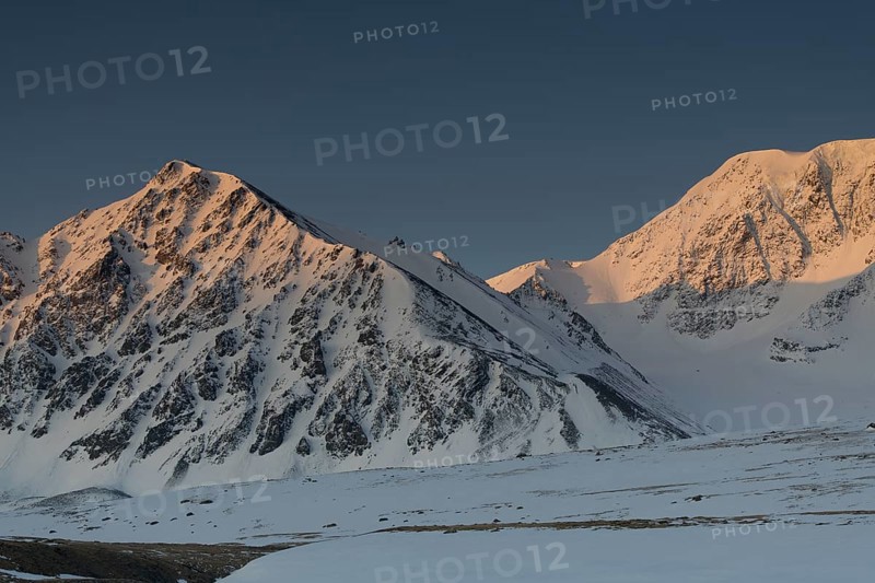 Sunrise over the mountain peaks in the snowy Tavan Bogd National Park, Mongolian Altai Mountains, Western Mongolia, Mongolia, Asia