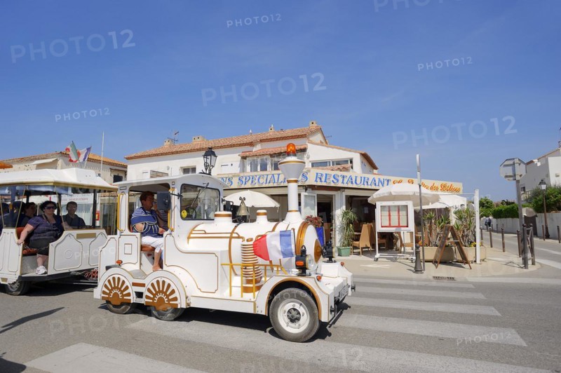 Railway or slow train in front of a restaurant, Les Saintes-Maries-de-la-Mer, Camargue, Bouches-du-Rhone, Provence-Alpes-Cote d'Azur, South of France, France, Europe