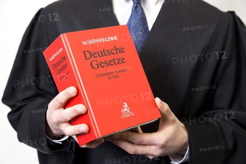 Lawyer in robe with German law book, 15.01.2015., Berlin, Berlin, Germany, Europe