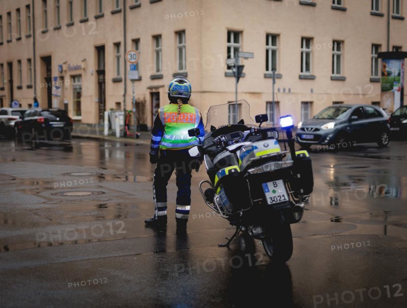 Policewoman with motorbike blocks road, taken during a demonstration in Berlin, 19/04/2024