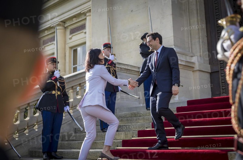 Annalena Baerbock (Alliance 90/The Greens), Federal Foreign Minister, takes a photo as part of her participation in the international humanitarian conference on Sudan and its neighbouring countries. Here she is greeted by Stephane Sejourne, Foreign Minister of France, at the Quai d'Orsay Foreign Ministry. 'Photographed on behalf of the Federal Foreign Office'
