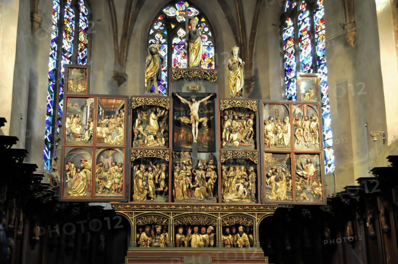 Kaysersberg, Alsace Wine Route, Alsace, Departement Haut-Rhin, France, Europe, Detailed wood carved altar with reliefs and a stained glass window behind it, Europe