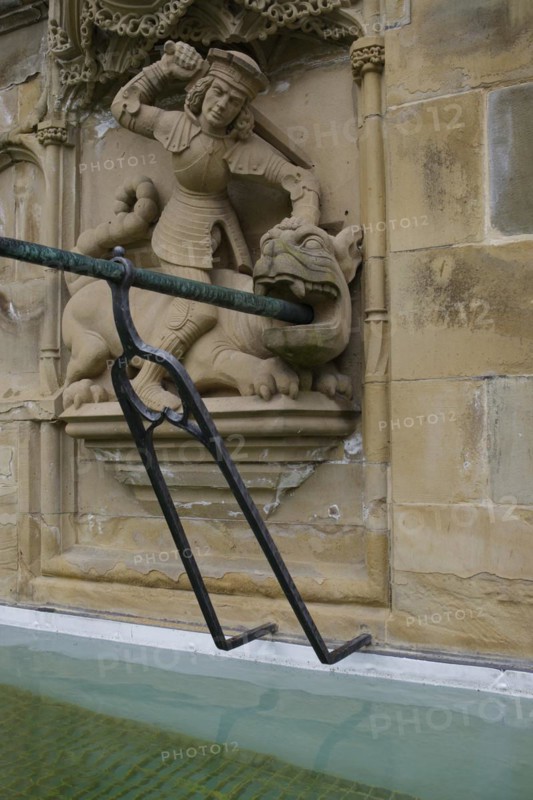 Dragon slayer motif on the fish fountain, dragon, sword, fountain, market fountain, old town, market square, Schwaebisch Hall, Hohenlohe, Heilbronn-Franken, Baden-Wuerttemberg, Germany, Europe