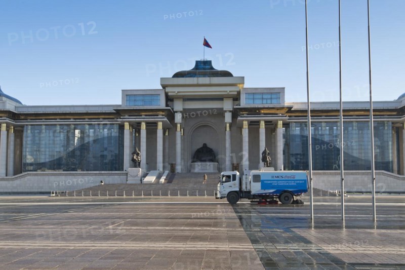 Cleaning vehicle, sweeper in front of Mongolian government palace, state palace, parliament building with statue of Genghis Khan in the capital Ulaanbaatar, Ulan Bator, Mongolia, Asia