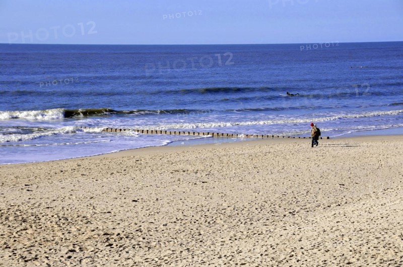 Westerland, Sylt, Schleswig-Holstein, Germany, Europe, Person walking along the edge of the sea along an extensive sandy beach, North Frisian Island, Schleswig Holstein, Europe
