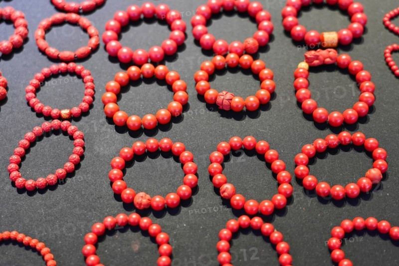 Chongqing, Chongqing Province, China, Asia, Collection of red handmade bracelets on a dark background, Asia