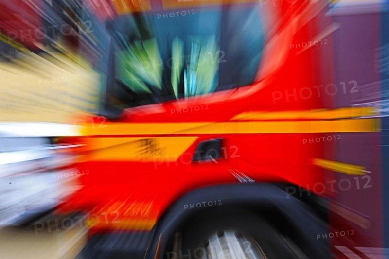 Focussed on the tyre, the image shows a fast-moving fire engine