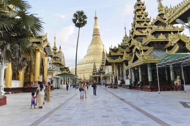 Shwedagon Pagoda, Yangon, Myanmar, Asia, Group of people and tourists in front of an imposing golden pagoda under a blue sky, Asia