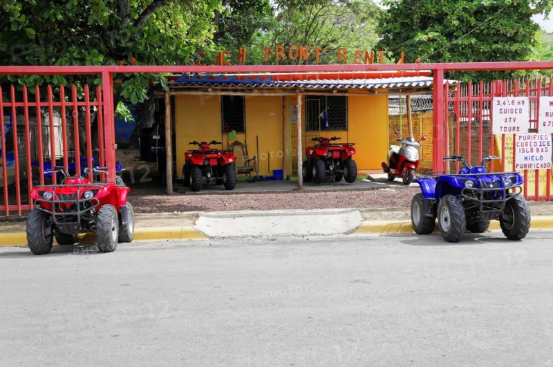 San Juan del Sur, Nicaragua, four-wheel drive vehicles for hire, parked in front of a colourful building with a fence, Central America, Central America