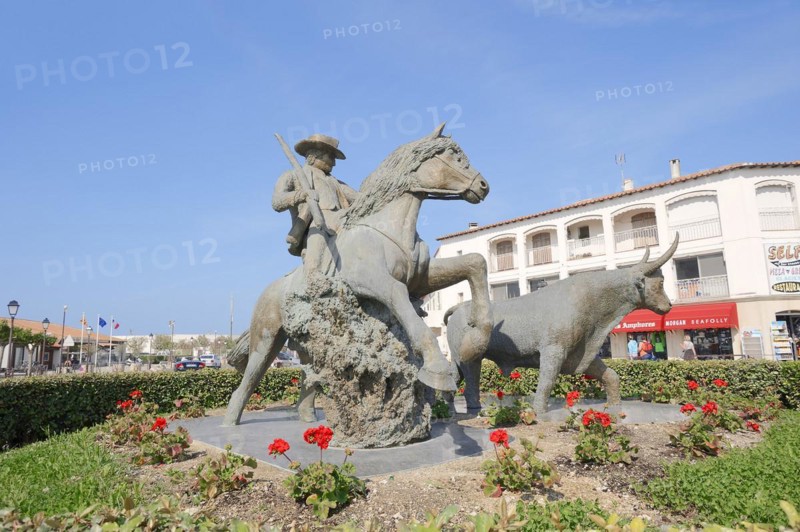 Statue of a drover with Camargue horse and Camargue bull, Les Saintes-Maries-de-la-Mer, Camargue, Bouches-du-Rhone, Provence-Alpes-Cote d'Azur, South of France, France, Europe