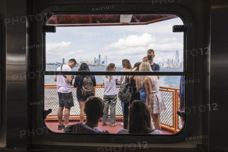 Tourists on the Staten Island ferry with a view of the Manhattan skyline, New York City, USA, New York City, New York, USA, North America