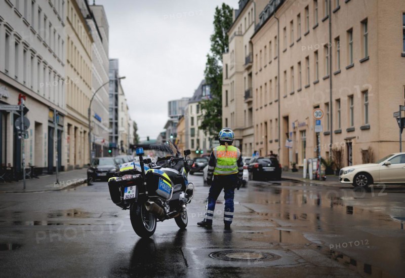 Policewoman with motorbike blocks road, taken during a demonstration in Berlin, 19/04/2024